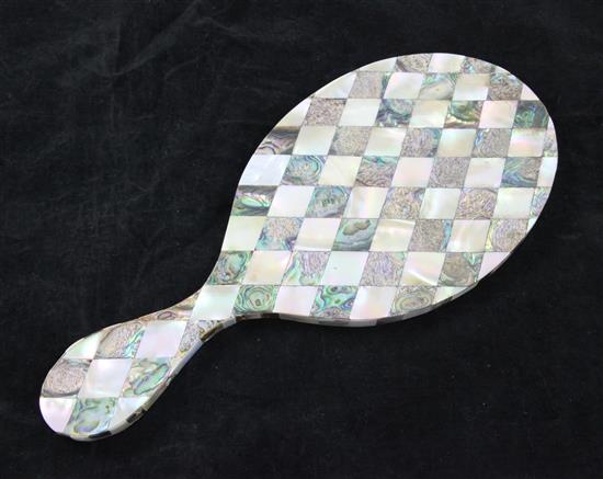 A Victorian hand mirror, completely veneered in Mother of Pearl